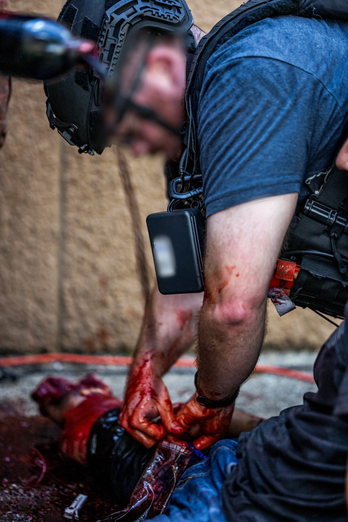 Officer performing hemorrhage control during scenario training